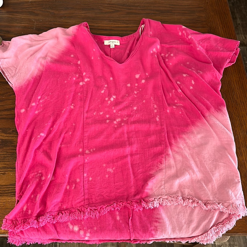 Pink with bleach spots on it.